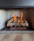 A gas log fire burning in a fireplace we serviced