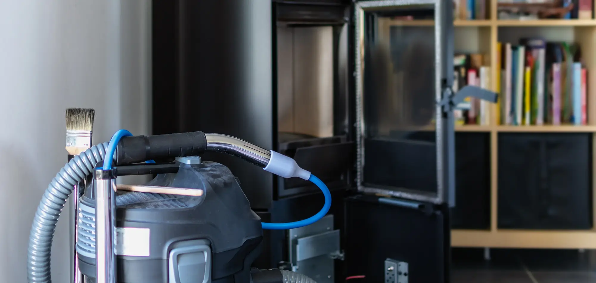 HEPA vacuum removing soot from a residential fireplace