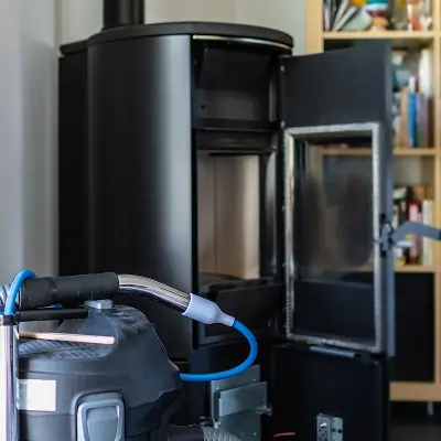 HEPA vacuum removing soot from a residential fireplace